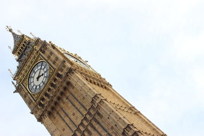 Low angle view of clock tower against sky