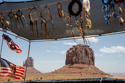 Monument valley rocks seen through a market stand selling indian flags and dreamcatchers