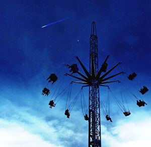 Low angle view of ferris wheel against sky