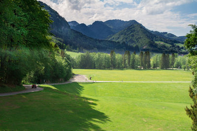 Scenic view of golf course against sky