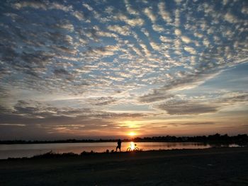 Scenic view of beach against sky during sunset