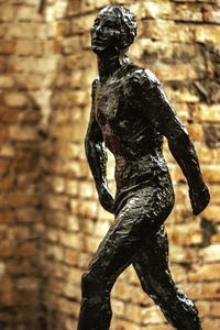 Rear view of statue against wall