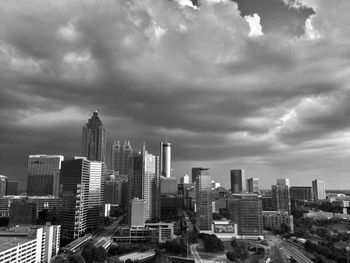 Cityscape against cloudy sky