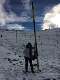 Woman standing on snow covered landscape