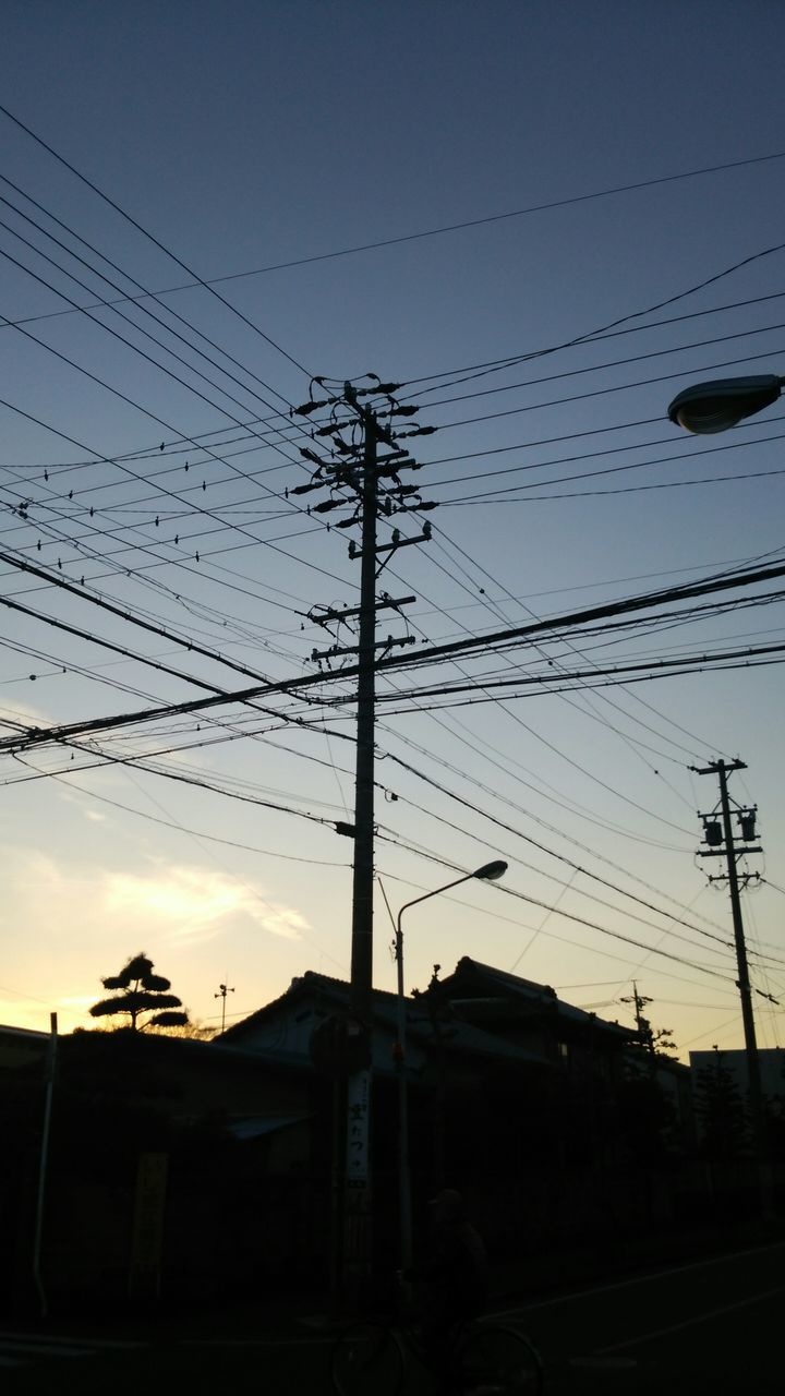 power line, electricity pylon, silhouette, electricity, power supply, cable, sunset, low angle view, connection, fuel and power generation, technology, sky, power cable, dusk, transportation, clear sky, street light, outdoors, built structure, building exterior