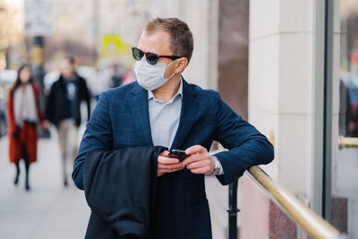 Young man wearing sunglasses while standing outdoors