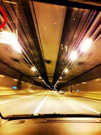 Cars in illuminated tunnel