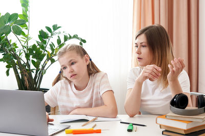 Mother helping daughter with homework