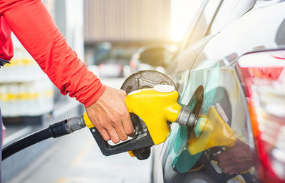 Midsection of man cleaning car