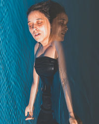 High angle view of young woman swimming in pool