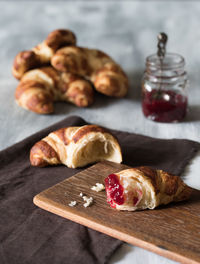 Close-up of croissants and jam on table