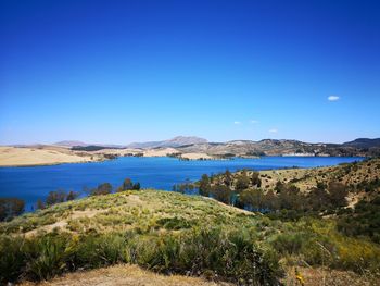 Scenic view of sea against clear blue sky