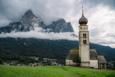 Historic building by mountains against sky