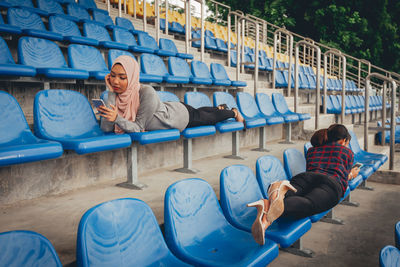 Rear view of people sitting on seat