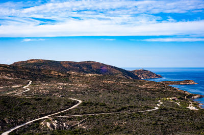 Scenic view of sea and mountains against sky