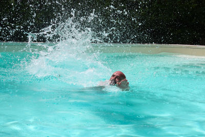 Portrait of man swimming in pool