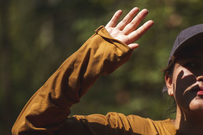 Close-up of man with hand raised