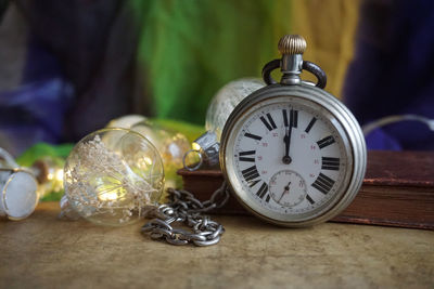 Close-up of old pocket watch on table