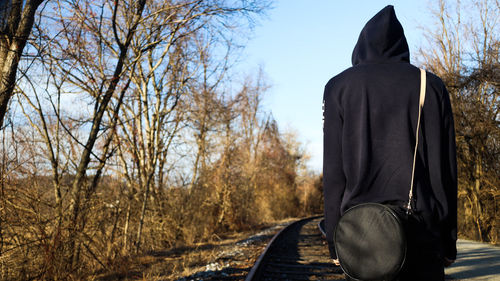 Rear view of woman sitting in park