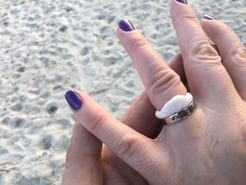Close-up of woman hand holding cigarette at beach