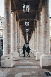 Rear view of people walking in building