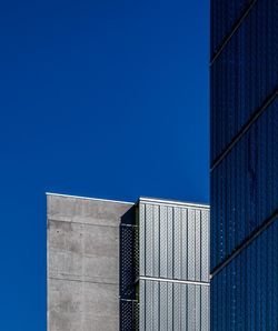 Low angle view of skyscraper against clear blue sky