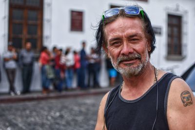 Portrait of smiling man on footpath