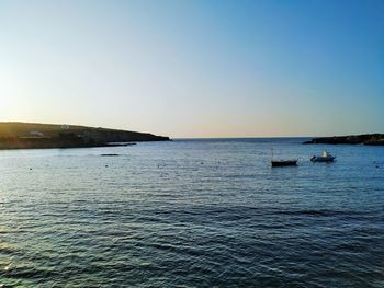 Scenic view of sea against clear sky during sunset