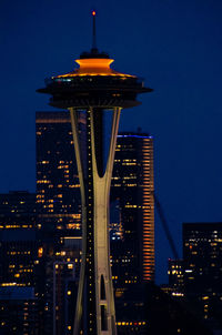 Illuminated buildings against sky at night