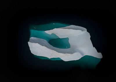 Aerial view of iceberg melting in sea