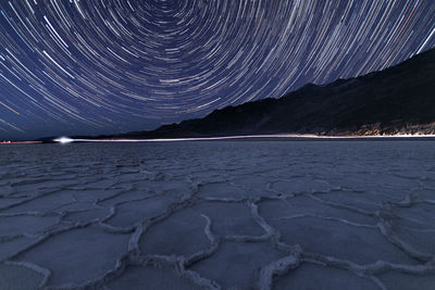 Scenic view of arid landscape against sky at night