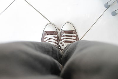 Low section of woman standing on tiled floor