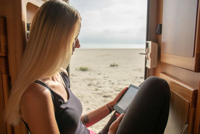 Rear view of young woman sitting in bus