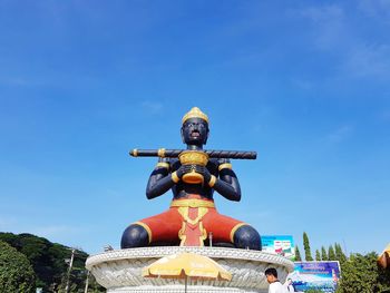 Low angle view of statue against blue sky