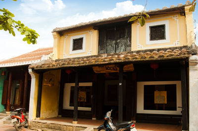 Exterior of house by building against sky