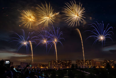 Silhouette people watching firework display during new year celebration