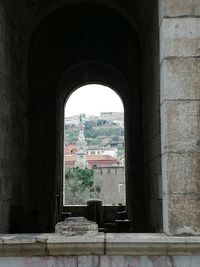 Buildings seen through arch window