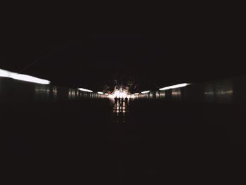 Illuminated tunnel in building at night