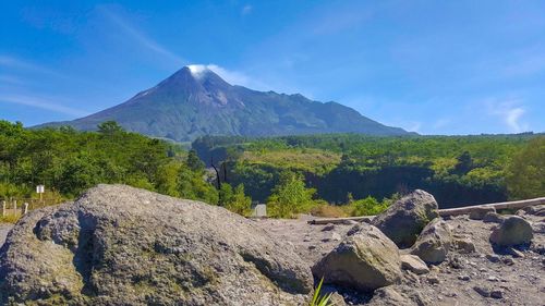 Scenic view of mountains against blue sky