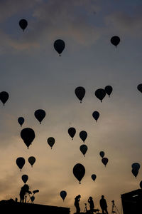 Low angle view of hot air balloons flying in sky