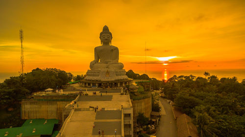 Statue of temple against sky during sunset