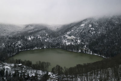 High angle view of lake amidst trees against sky