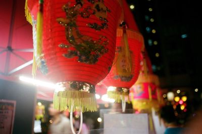 Low angle view of illuminated lanterns hanging at night