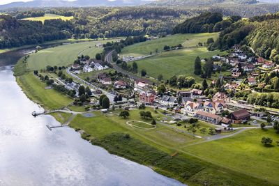 High angle view of trees and houses on field