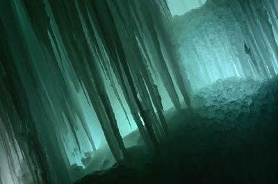 Low angle view of icicles on landscape during winter