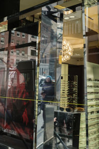 Reflection of people on glass window in store