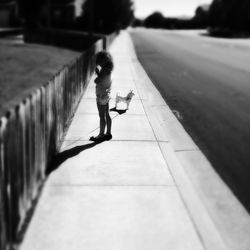 Rear view of woman walking on road