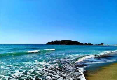 Scenic view of sea against clear blue sky