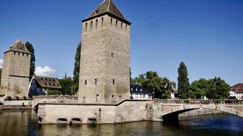 Bridge over river against buildings