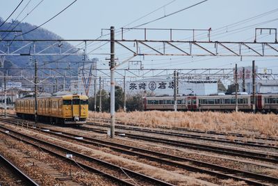 Train on railroad tracks against clear sky